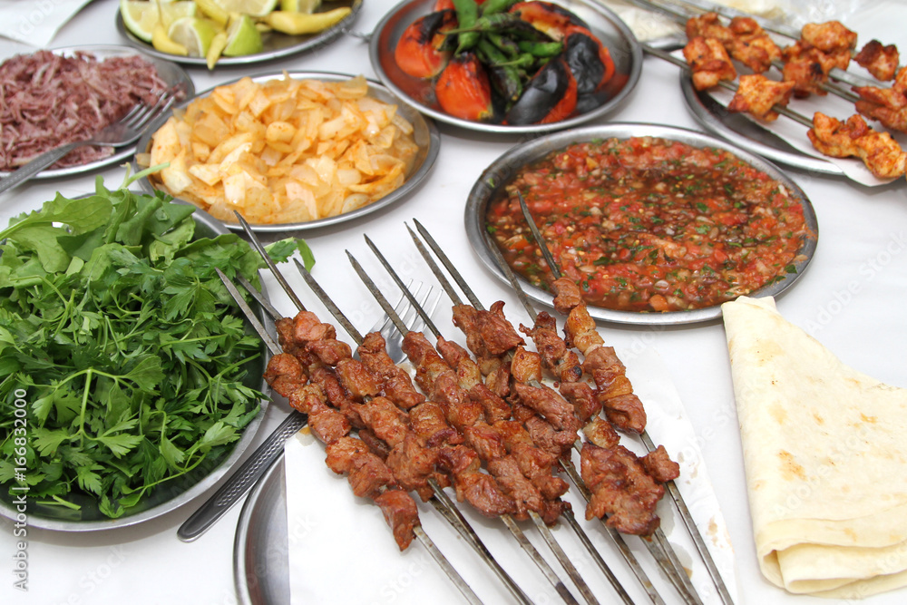 Turkish shish kebab with various salads and grilled vegetables Turkish shish kebab with various salads and grilled vegetables