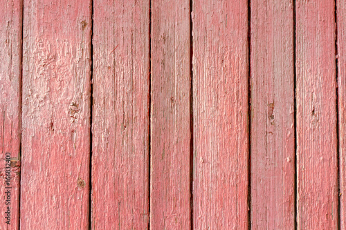 Texture of old wood with worn pink paint