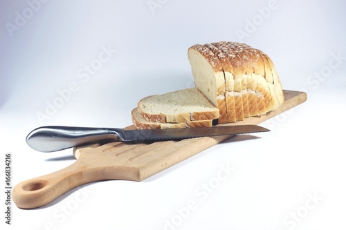 Sliced bread on the cuttin board with knife photo