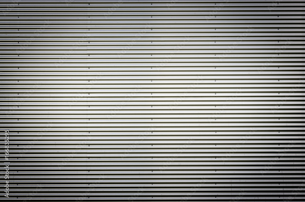 Corrugated metal sheet. Silver gray background pattern with nice vignetting.