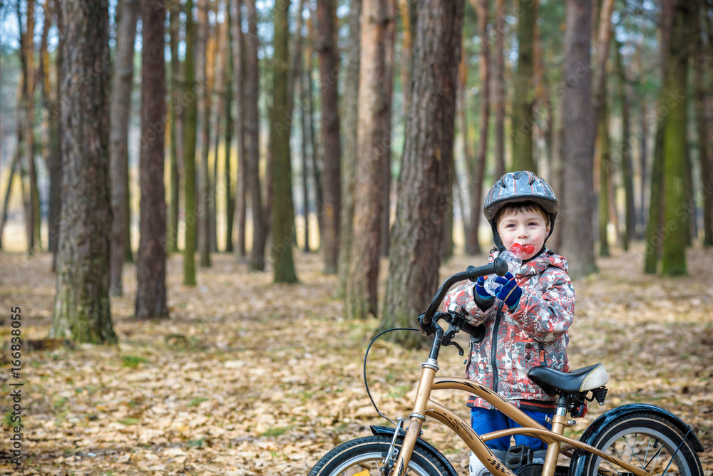 Young boy with bicycle with drinking clear water Young boy with bicycle with drinking clear water