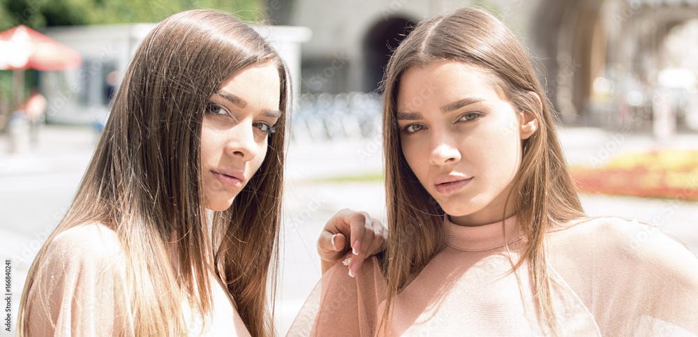 Two beautiful twins sisters spending time together. Two beautiful twins sisters spending time together.