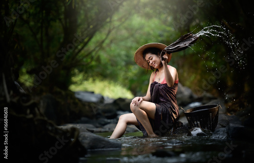 Fototapeta Naklejka Na Ścianę i Meble -  Beautiful asian woman in waterfall
