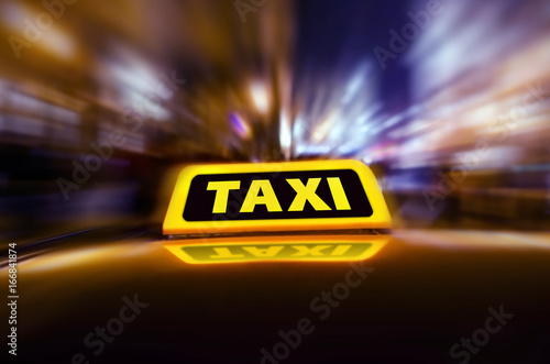 Taxi car on the street at night