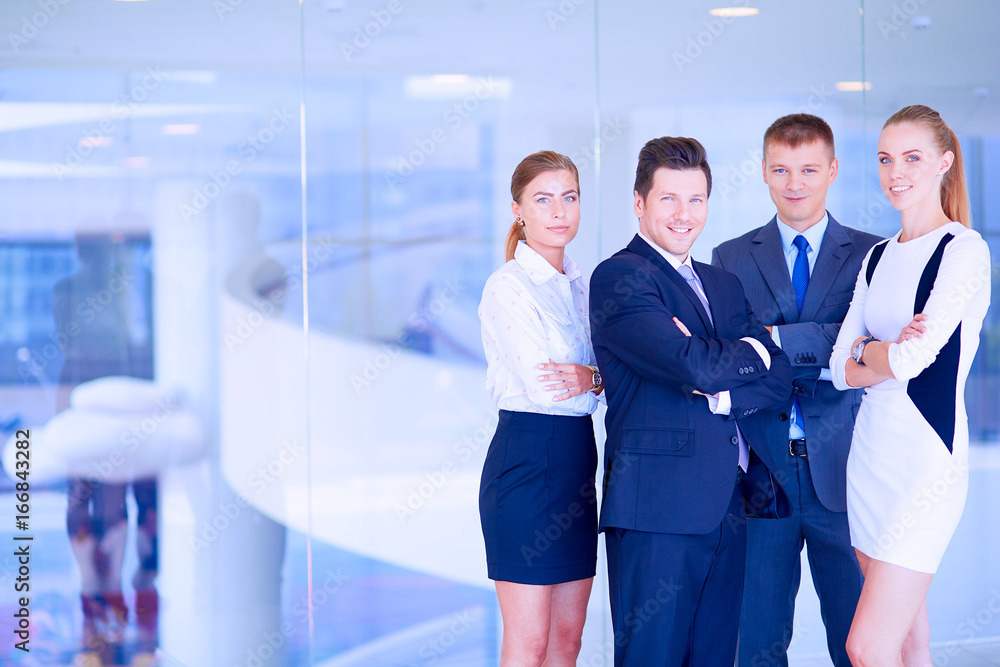 Young businesspeople standing in modern office lobby Young businesspeople standing in modern office lobby