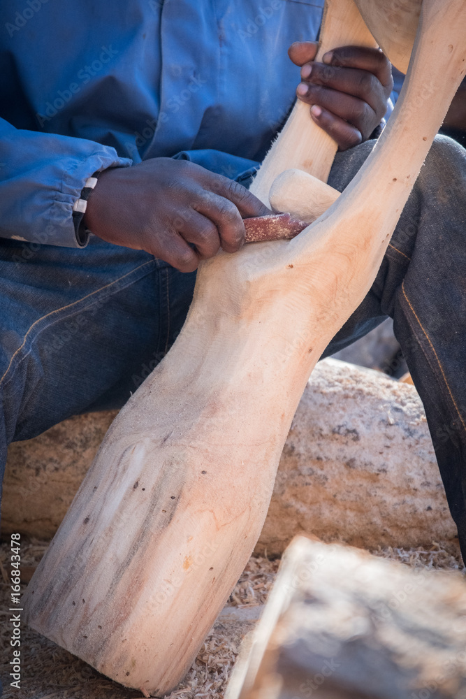 sanding a wooden sculpture sanding a wooden sculpture