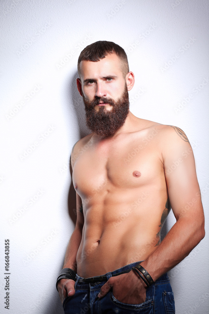 Fototapeta premium Portrait of handsome man standing, isolated on grey background