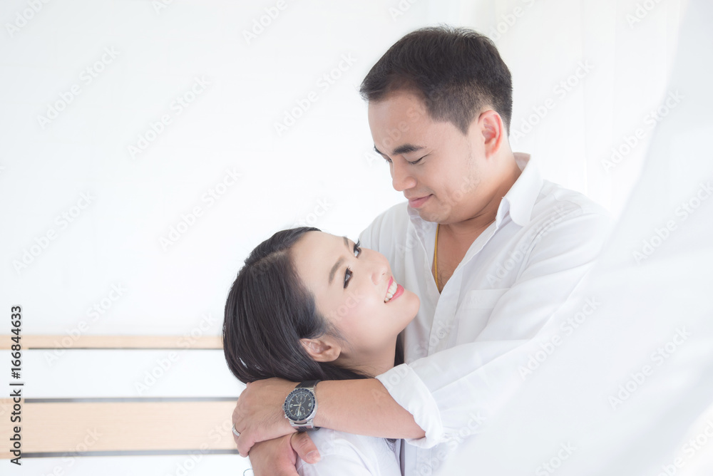 Asian couple smiling together after waking up in the morning Asian couple smiling together after waking up in the morning