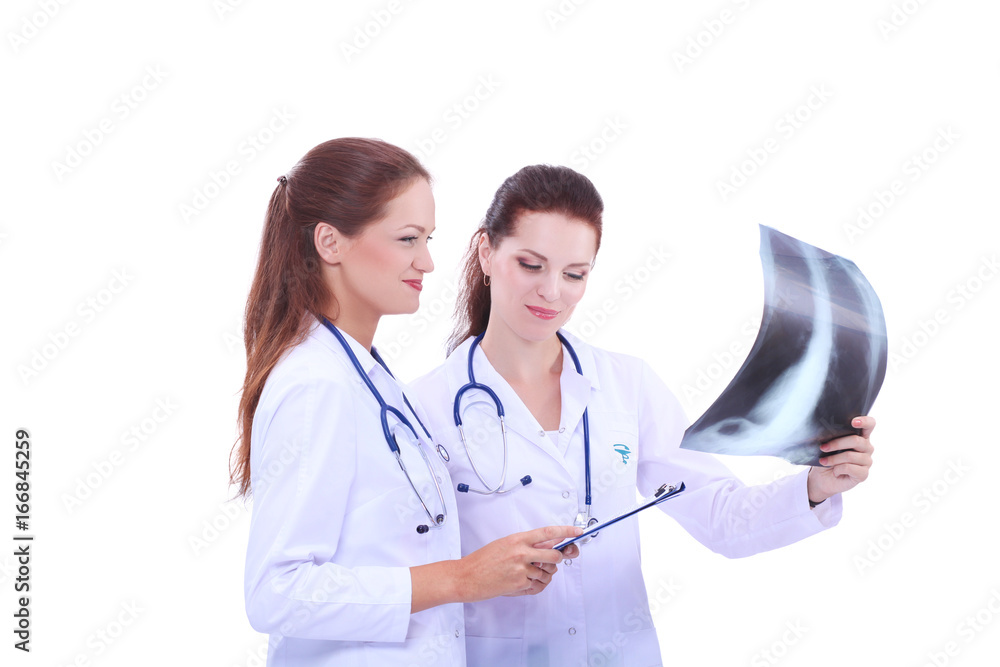Two woman nurse watching X Ray image, standing in hospital Two woman nurse watching X Ray image, standing in hospital