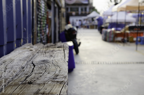 Wooden table top and blurred street market background usage or create montage.