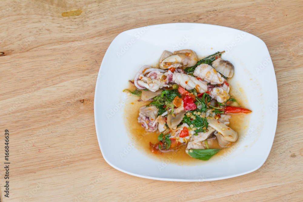 spicy stir fried squid with mushroom and basil leaf