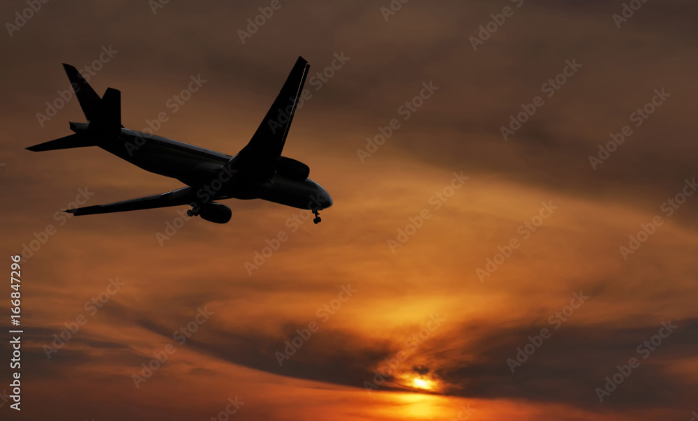 Airplane is landing on sunset.