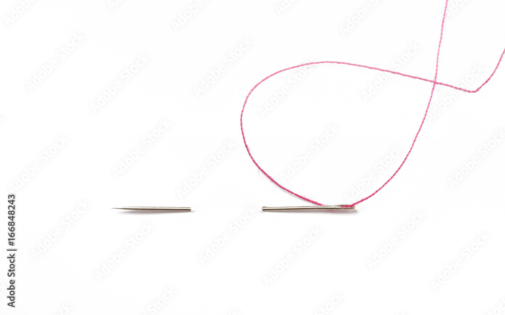 Sewing needle with red thread through the white background Sewing needle with red thread through the white background