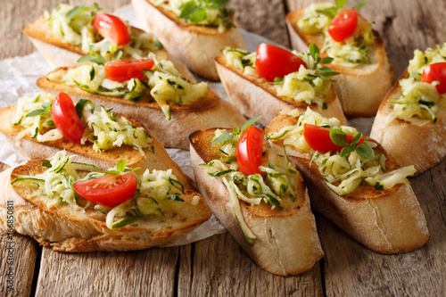Vegetarian healthy sandwiches with grated zucchini, oregano and tomatoes close-up. horizontal