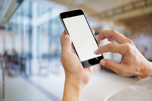 Businessman using Smartphone. Blank screen mobile phone for graphic display montage.