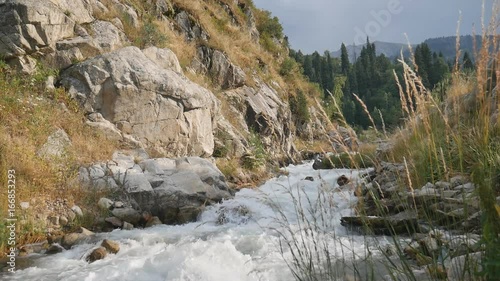 Mighty  river in the mountains. Trans-Ili Alatau. photo