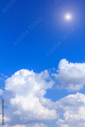 Blue sky background with white clouds rain clouds and sunshine on sunny summer or spring day. © phanthit malisuwan