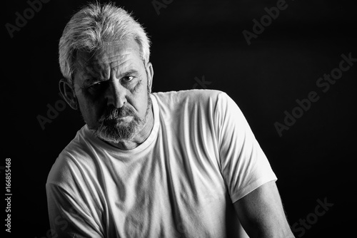 Serious mature man with white hair and beard