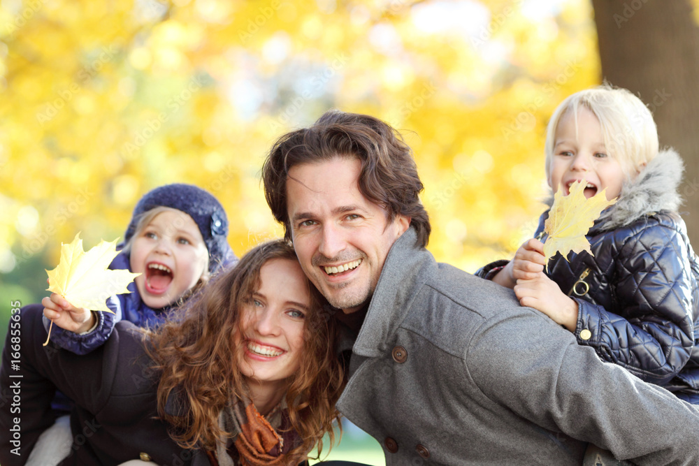 Fototapeta premium Parents giving children piggyback ride