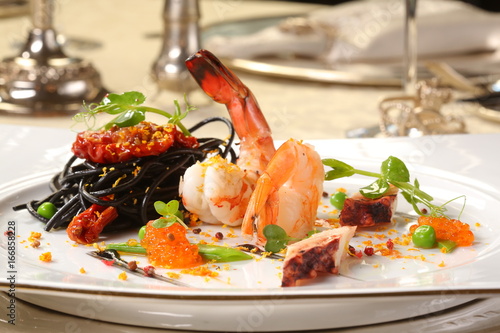 Fine dining - spaghetti nero with seafood and orange