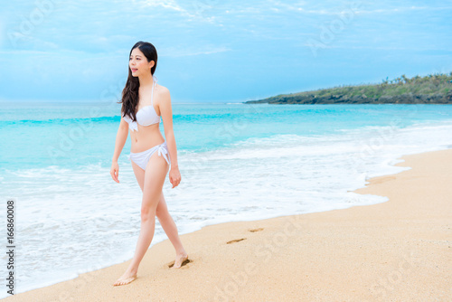 leisurely pretty female traveler wearing bikini