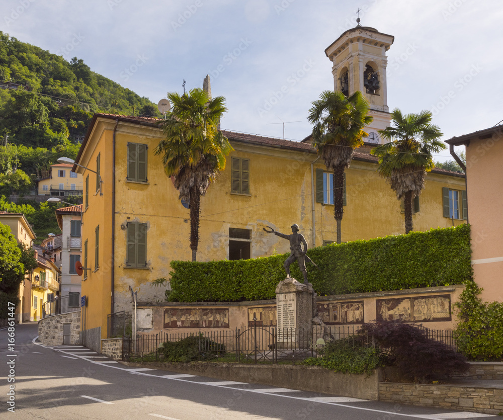 The village center of Maccagno on Lake Maggiore with a war memorial - Maccagno, Lake Maggiore, Varese, Lombardy, Italy