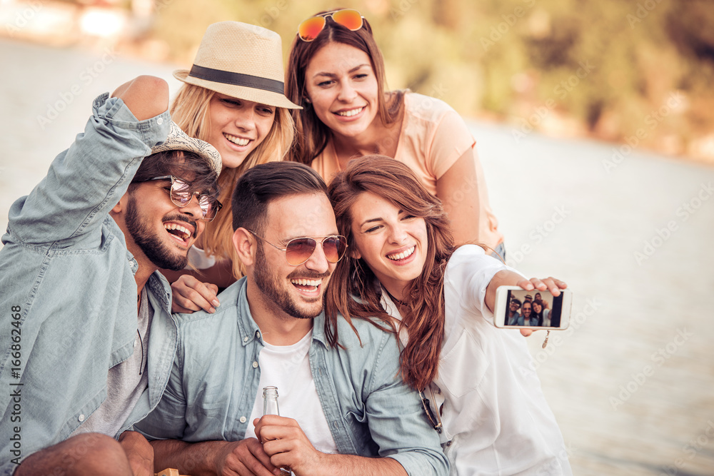Group of friends taking selfie on the beach Group of friends taking selfie on the beach