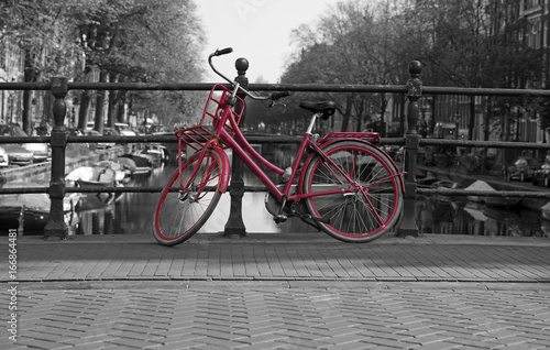Black and white view of Amsterdam with redbicycle