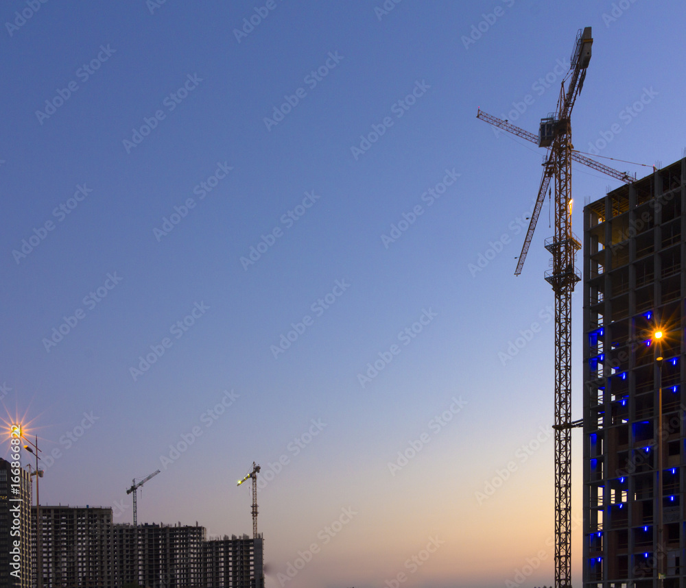 Naklejka premium Construction of high-rise building tower crane