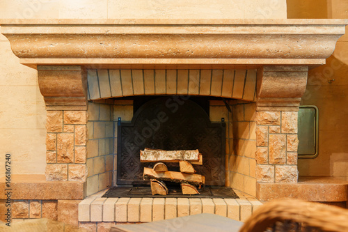 Stack of firewood in mmodern chimney fire-box. photo