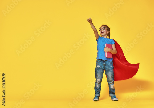 child plays superhero