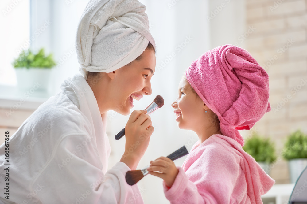 Mom and child are in bathrobes Mom and child are in bathrobes