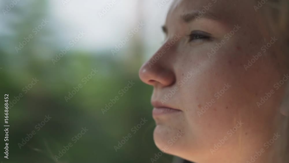 handheld shot of happy teen girl enjoys wind in summer day traveling in car handheld shot of happy teen girl enjoys wind in summer day traveling in car