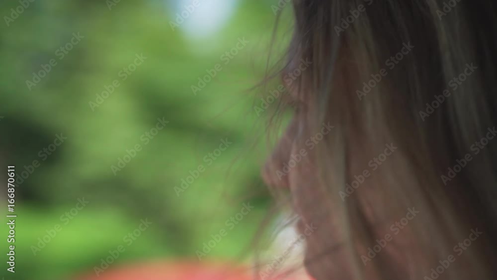 handheld shot of happy teen girl enjoys wind in summer day traveling in car handheld shot of happy teen girl enjoys wind in summer day traveling in car