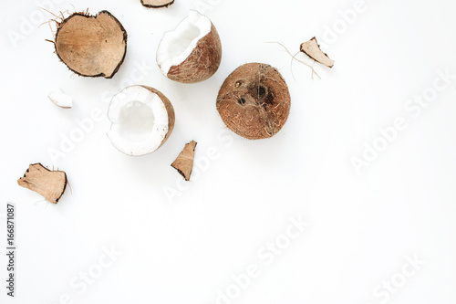 Cracked coconut on white background. Flat lat, top view