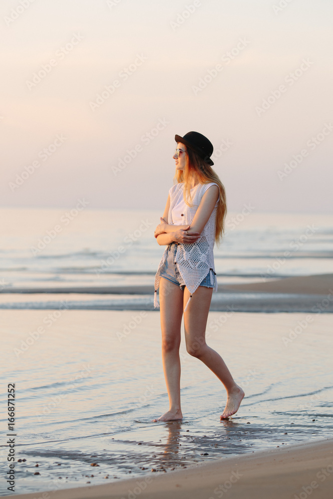 Woman in white crop top and blue denim jeans standing on beach shore during  daytime photo – Free Maldives Image on Unsplash