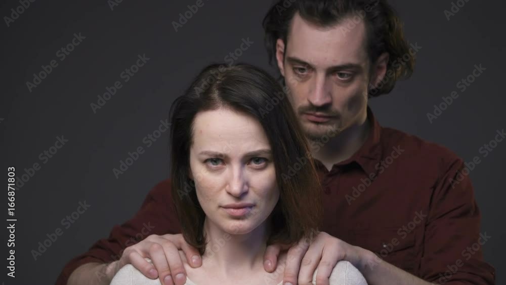Domestic violence, man's hands keeping woman's shoulders, zoom in Domestic violence, man's hands keeping woman's shoulders, zoom in