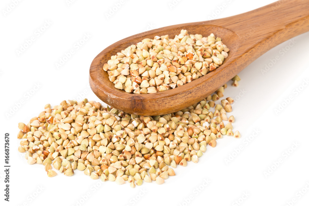 Raw, natural, uncooked buckwheat seed kernels in wooden spoon Raw, natural, uncooked buckwheat seed kernels in wooden spoon