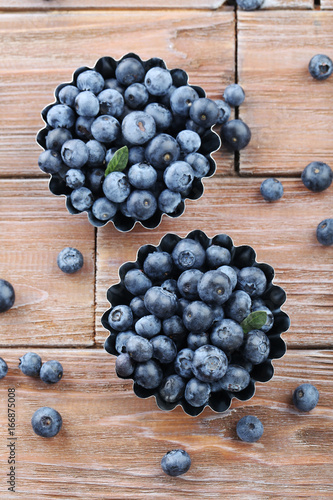 Ripe and tasty blueberries on brown wooden table