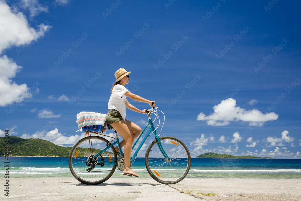 Fototapeta premium Woman ride along The Beach