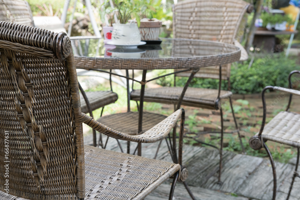 wicker rattan chair and table on patio in garden wicker rattan chair and table on patio in garden