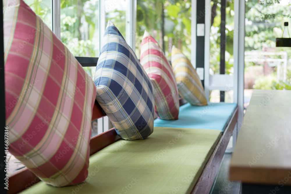 colorful pillow on wood chair with fabric cushion in restaurant or cafe coffee shop colorful pillow on wood chair with fabric cushion in restaurant or cafe coffee shop