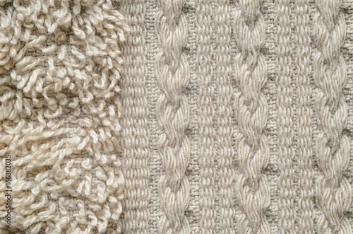 A macro shot of an element of beige color towel. Fleecy part and decorative element with braided pigtails. Texture is similar to the texture of a fleecy knotted-pile carpet.