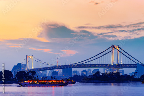 sunset twilight of tokyo skyline, with cityscape and Rainbow Bridge at Odaiba Seaside Park, Odiaba, Tokyo, Japan