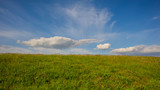 Spring landscape - clouds and field in the steppe.