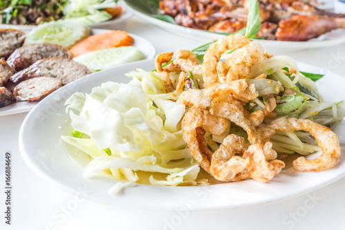 Lao papaya salad on white dish for lunch or dinner.