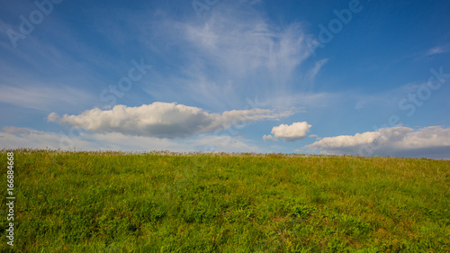 Spring landscape - clouds and field in the steppe.