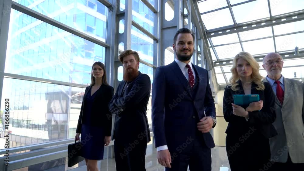 Business team walking in modern glass office building Business team walking in modern glass office building