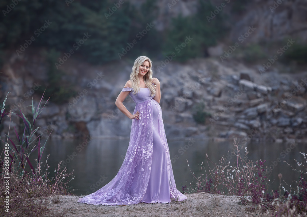 A pretty woman in a beautiful, purple dress with a long train. Fantastic picture of pregnancy. Creative colors. A pretty woman in a beautiful, purple dress with a long train. Fantastic picture of pregnancy. Creative colors.