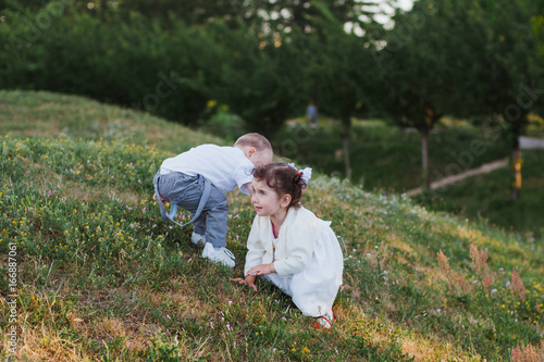 Boy and girl on a hill on the grass